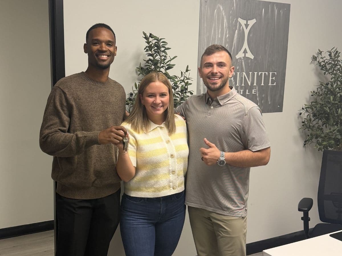 Sydney at title company closing day, keys in hand.